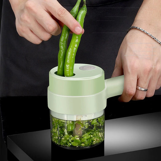 Handheld green vegetable chopper with green beans being chopped.